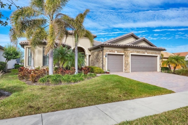 mediterranean / spanish-style home with a garage and a front lawn