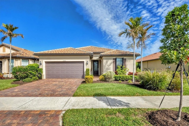 view of front of home with a garage and a front yard