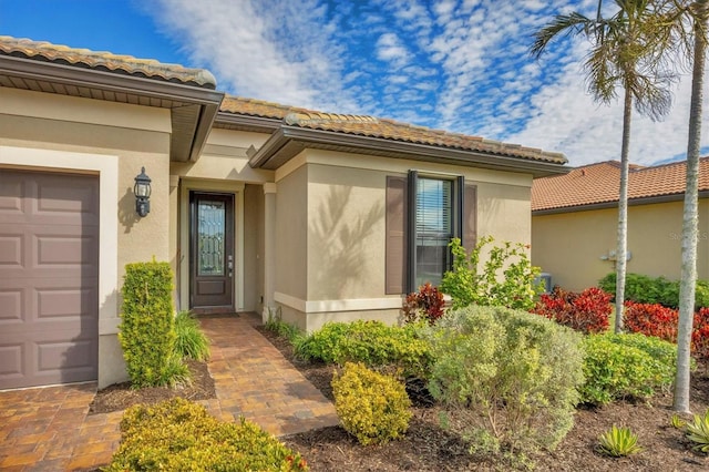 doorway to property with a garage