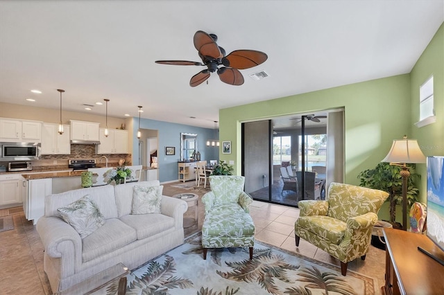 tiled living room featuring ceiling fan