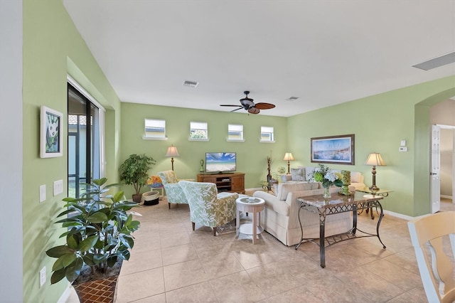 tiled living room with ceiling fan