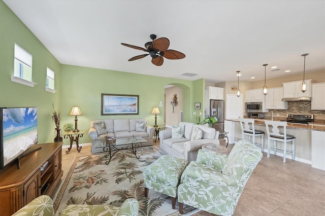 living room with ceiling fan and light tile patterned flooring