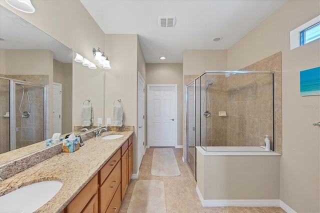 bathroom with a shower with door and vanity