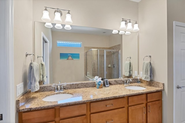 bathroom featuring a shower with door and vanity