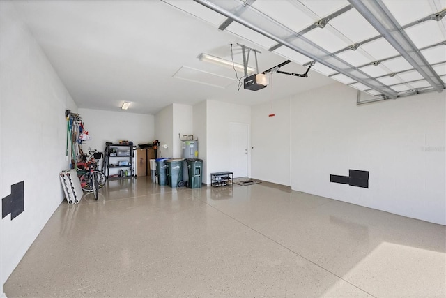 garage with a garage door opener and electric water heater