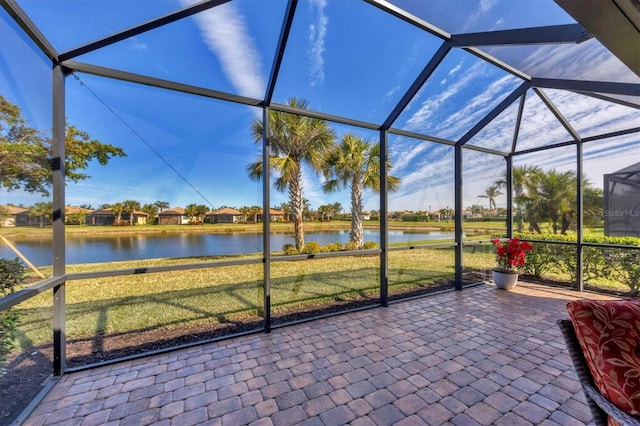 unfurnished sunroom featuring a water view