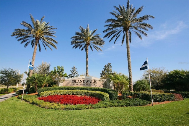 community sign featuring a lawn