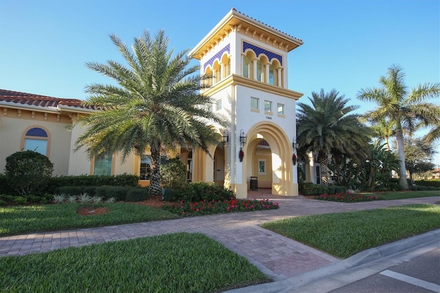 mediterranean / spanish-style home featuring a front yard