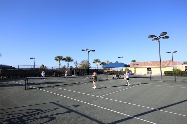 view of tennis court featuring basketball hoop