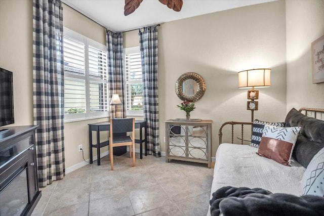 living room with ceiling fan and a wealth of natural light