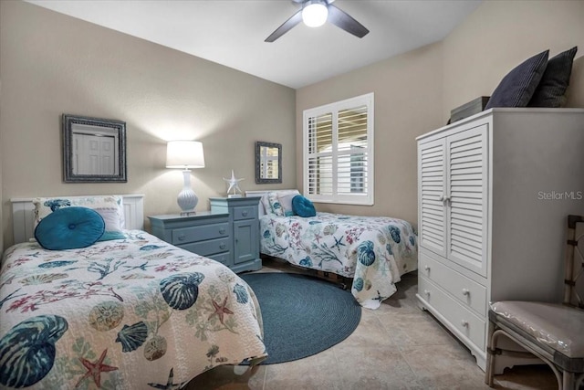 bedroom featuring light tile patterned floors and ceiling fan