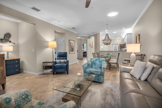 living room with ceiling fan, ornamental molding, and light tile patterned floors