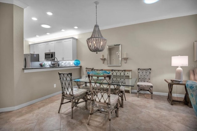 dining room with an inviting chandelier and crown molding