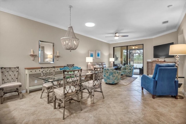 dining area featuring ceiling fan with notable chandelier and ornamental molding