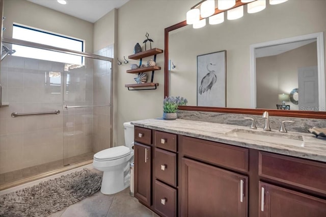 bathroom featuring tile patterned floors, vanity, toilet, and an enclosed shower