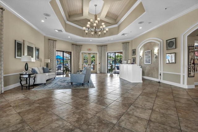 living room featuring a towering ceiling, ornamental molding, coffered ceiling, an inviting chandelier, and french doors