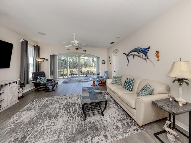 living room featuring hardwood / wood-style flooring, ceiling fan, and a wealth of natural light