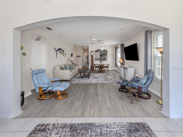 tiled living room featuring ceiling fan