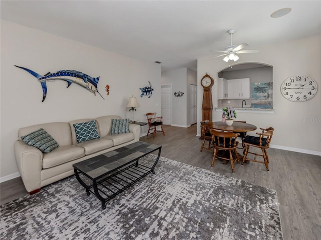 living room featuring hardwood / wood-style flooring and ceiling fan