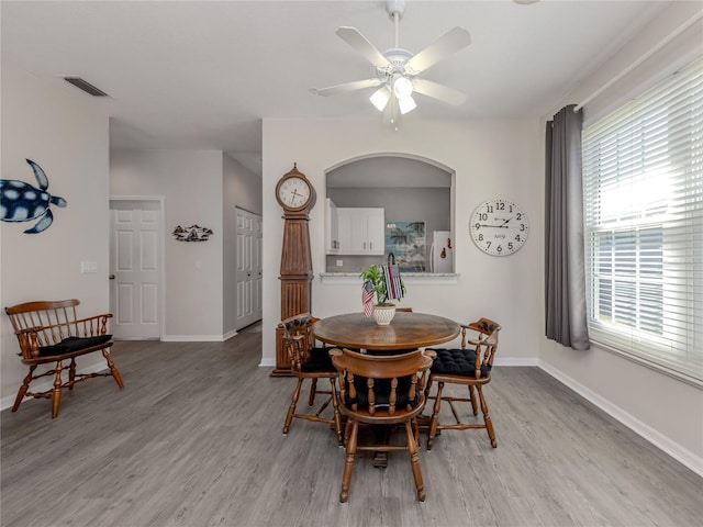 dining space featuring ceiling fan and light wood-type flooring