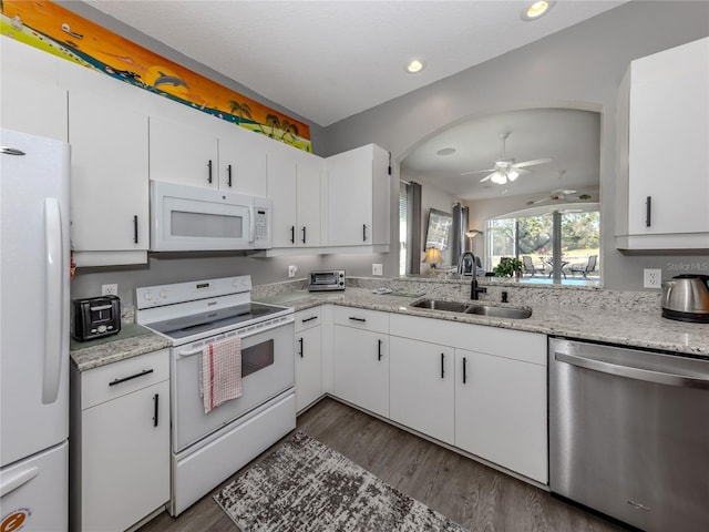 kitchen with dark wood-type flooring, sink, white cabinetry, ceiling fan, and white appliances