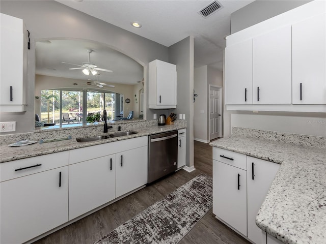 kitchen featuring sink, white cabinets, stainless steel dishwasher, light stone counters, and dark wood-type flooring