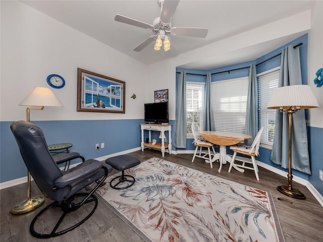 sitting room with hardwood / wood-style floors and ceiling fan