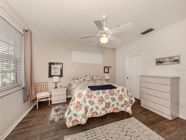 bedroom with dark wood-type flooring and ceiling fan