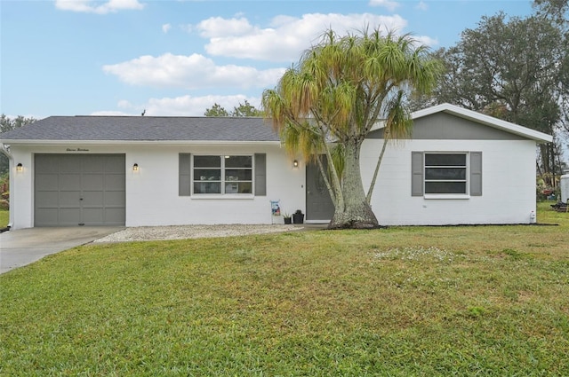 ranch-style home with a garage and a front lawn