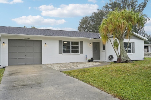 ranch-style home with a garage and a front lawn