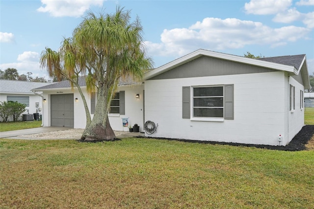 single story home with a garage, central AC, and a front yard