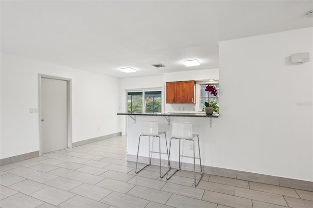 kitchen with a kitchen breakfast bar and kitchen peninsula