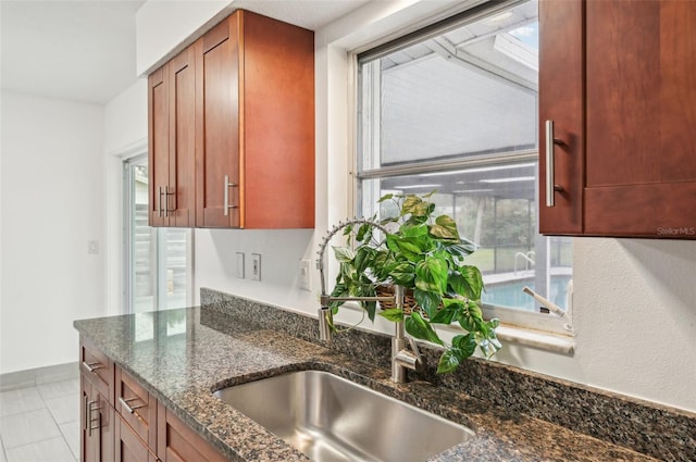 kitchen featuring dark stone countertops and sink