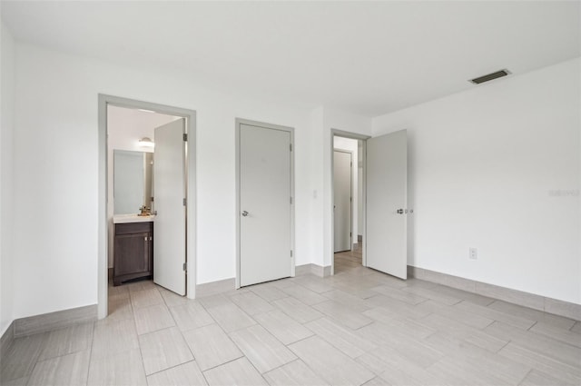 unfurnished bedroom featuring ensuite bathroom