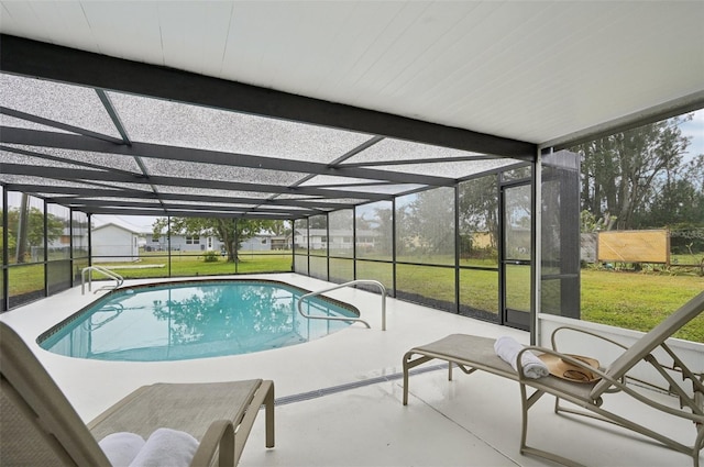 view of swimming pool featuring a yard, a patio area, and glass enclosure