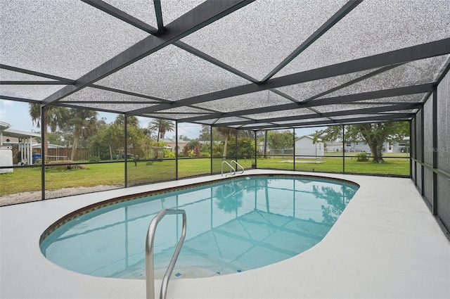 view of swimming pool with a lanai and a yard