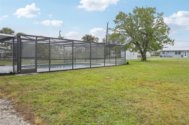 view of yard with a fenced in pool and a lanai