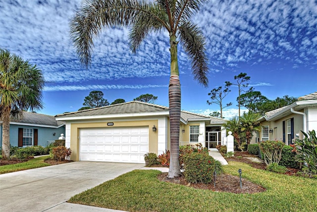 ranch-style home with a garage and a front lawn