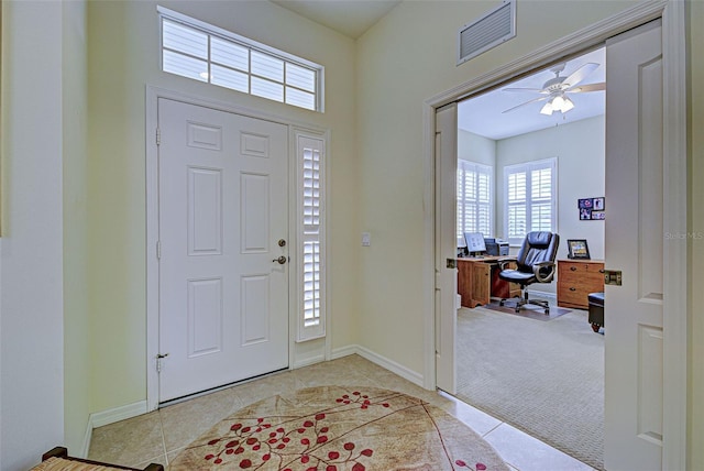 carpeted entrance foyer featuring ceiling fan