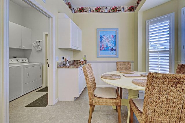 tiled dining area featuring washer and clothes dryer