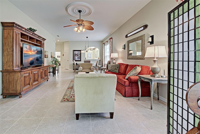 living room featuring light tile patterned flooring and ceiling fan with notable chandelier