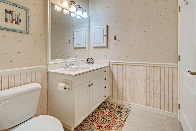 bathroom with tile patterned floors, toilet, and vanity