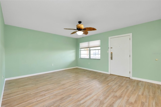 empty room with ceiling fan and light hardwood / wood-style floors