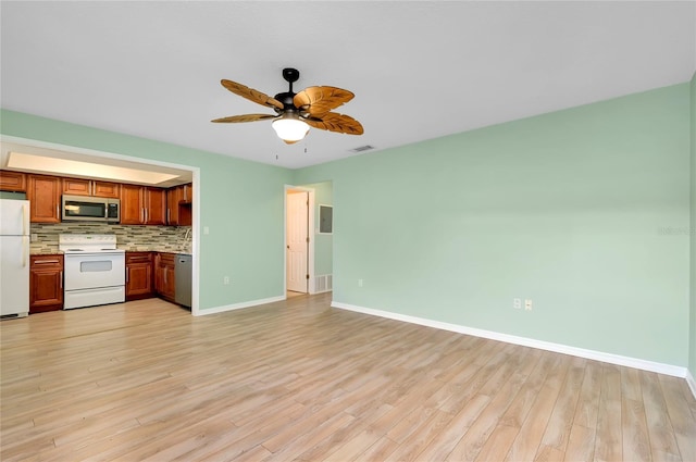 kitchen with ceiling fan, white appliances, light hardwood / wood-style floors, and backsplash