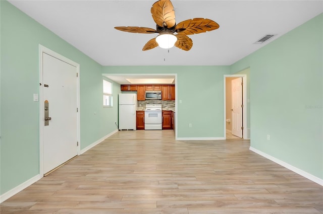 unfurnished living room with ceiling fan and light wood-type flooring