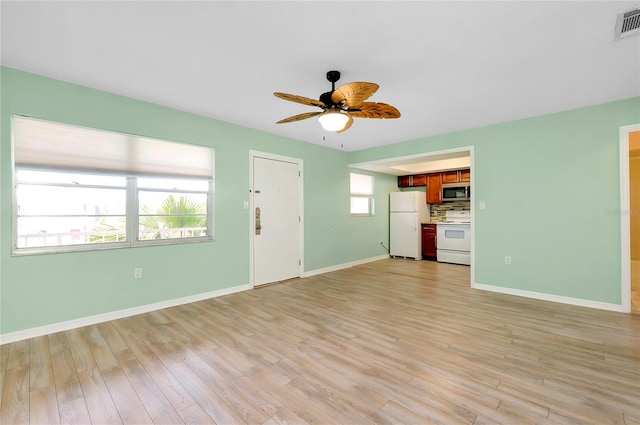 unfurnished living room with ceiling fan and light hardwood / wood-style floors