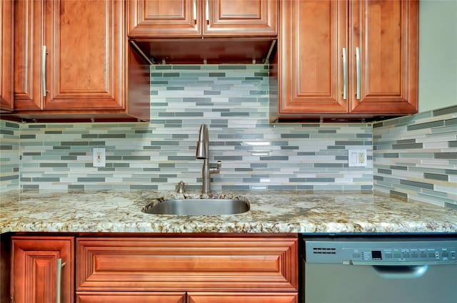 kitchen featuring tasteful backsplash, dishwasher, sink, and light stone counters