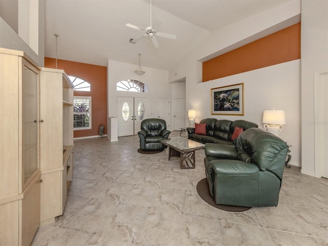 living room with ceiling fan and high vaulted ceiling