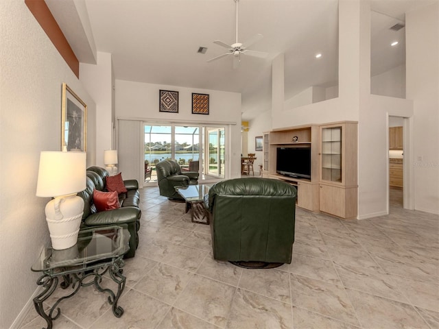 living room featuring ceiling fan and high vaulted ceiling