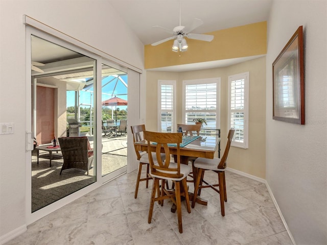 dining room with lofted ceiling and ceiling fan